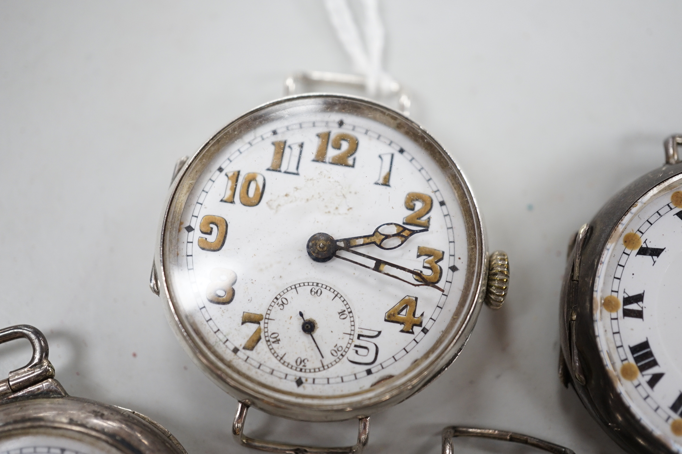 Five assorted early to mid 20th century manual wind wrist watches, including four silver.